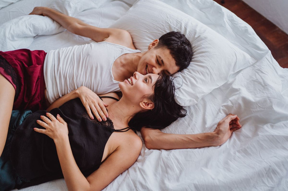 Playful couple being close in bed