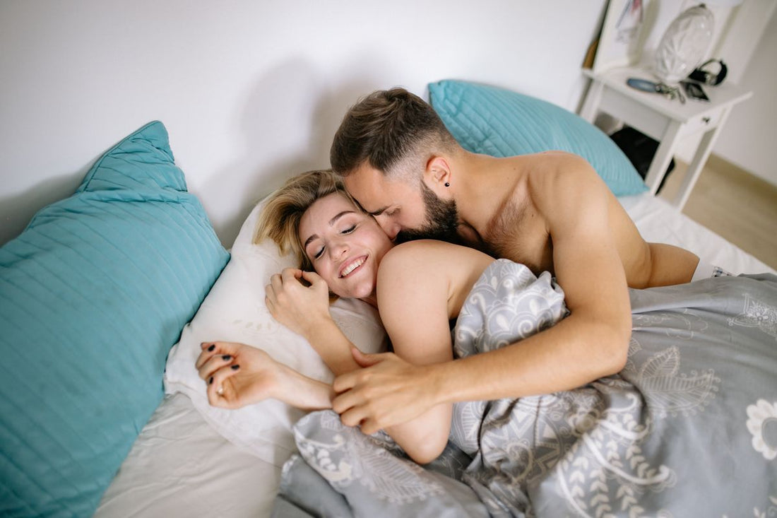 An affectionate couple cuddling closely in a cozy bedroom