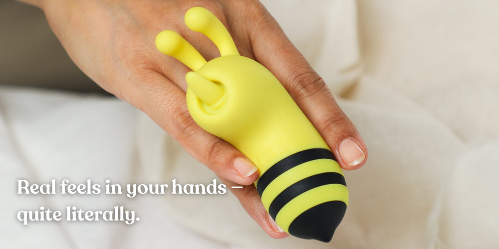 Yellow bee-shaped object held in a hand with text 'Real feels in your hands - quite literally.'